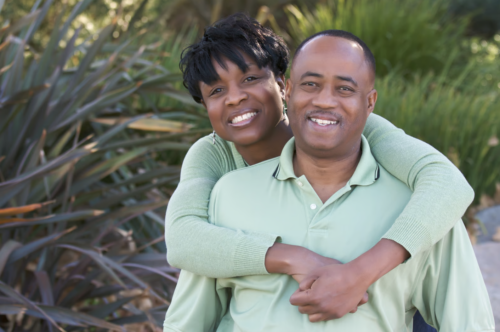 African American couple hugging and smiling